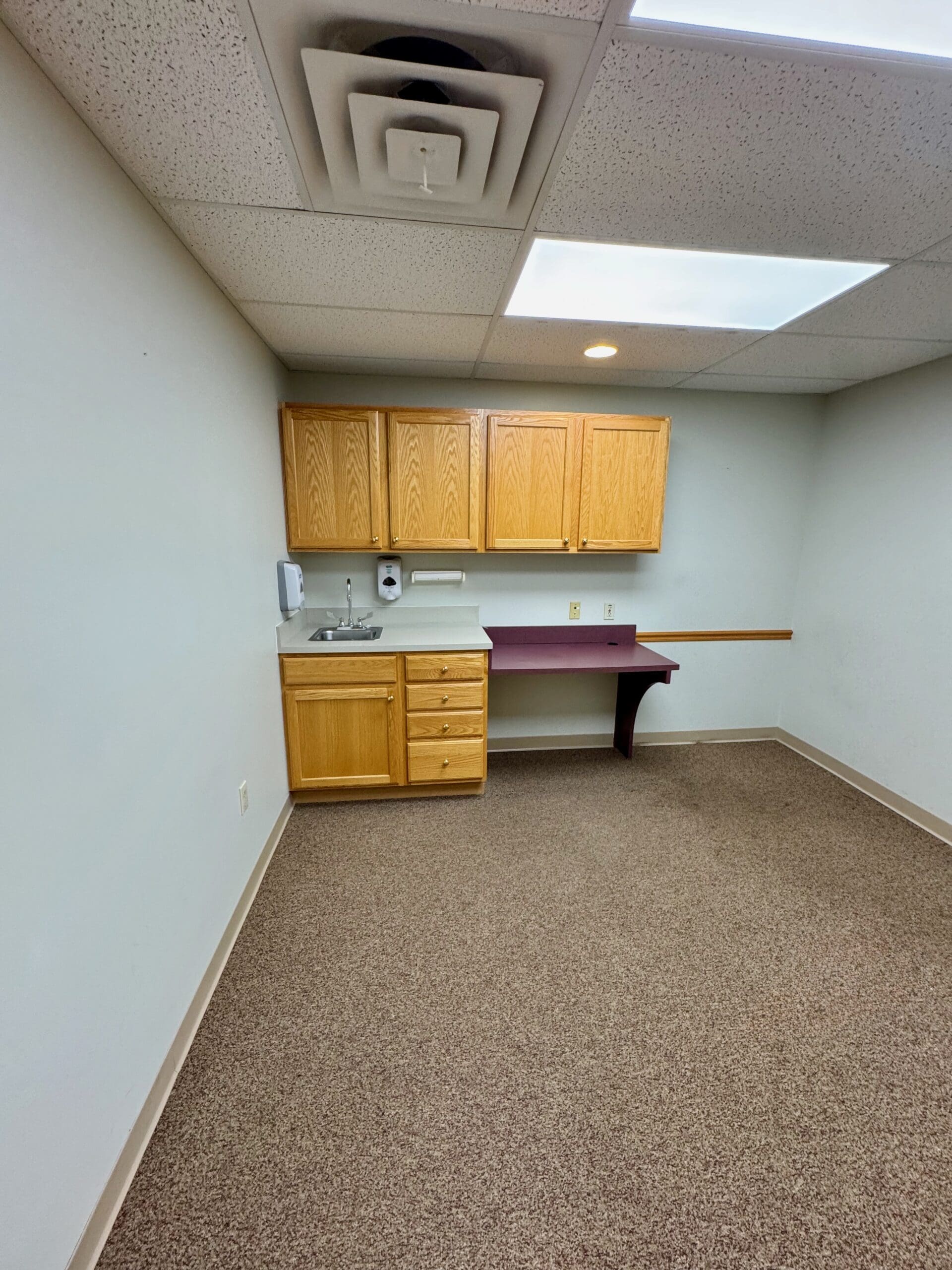 Medical exam room with built-in cabinets and sink at 500 Legacy Plaza West in Sagamore Business Center