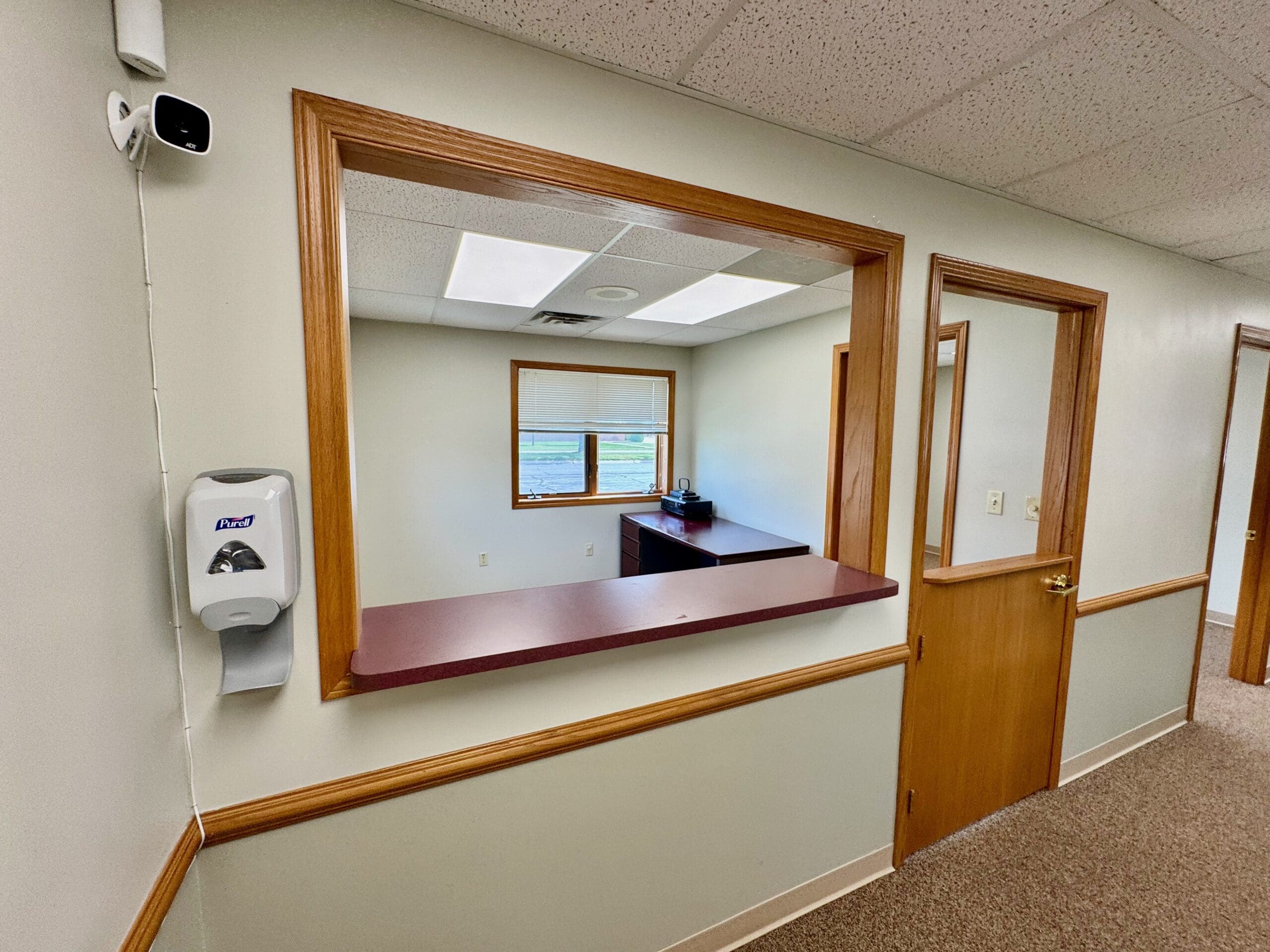 Reception window between the waiting room and front office in a medical suite at 500 Legacy Plaza West