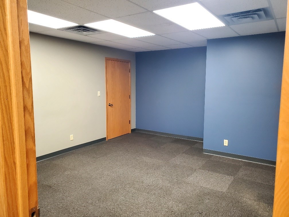 Additional conference room with blue accent wall in office space for lease at 304 Legacy Plaza West