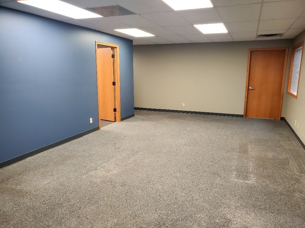 Open lobby with blue accent walls in office space for lease at 304 Legacy Plaza West, La Porte