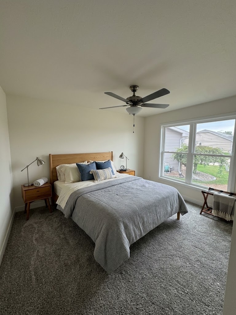 Guest bedroom with ceiling fan and natural light at 74 Prince William Court in Whispering Meadows