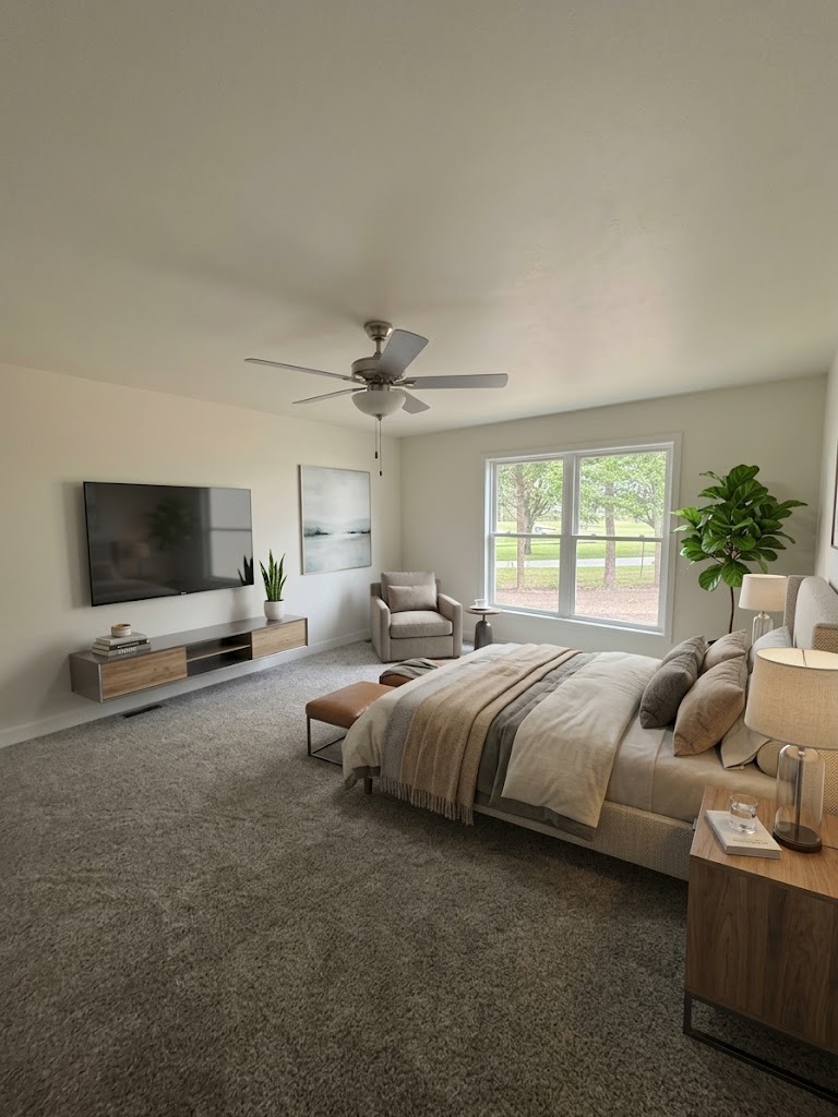 Primary bedroom with ceiling fan and large windows at 74 Prince William Court, a new home in La Porte
