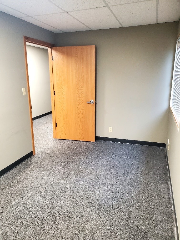 Private office with carpet and wood door in leasable office space at 304 Legacy Plaza West, La Porte